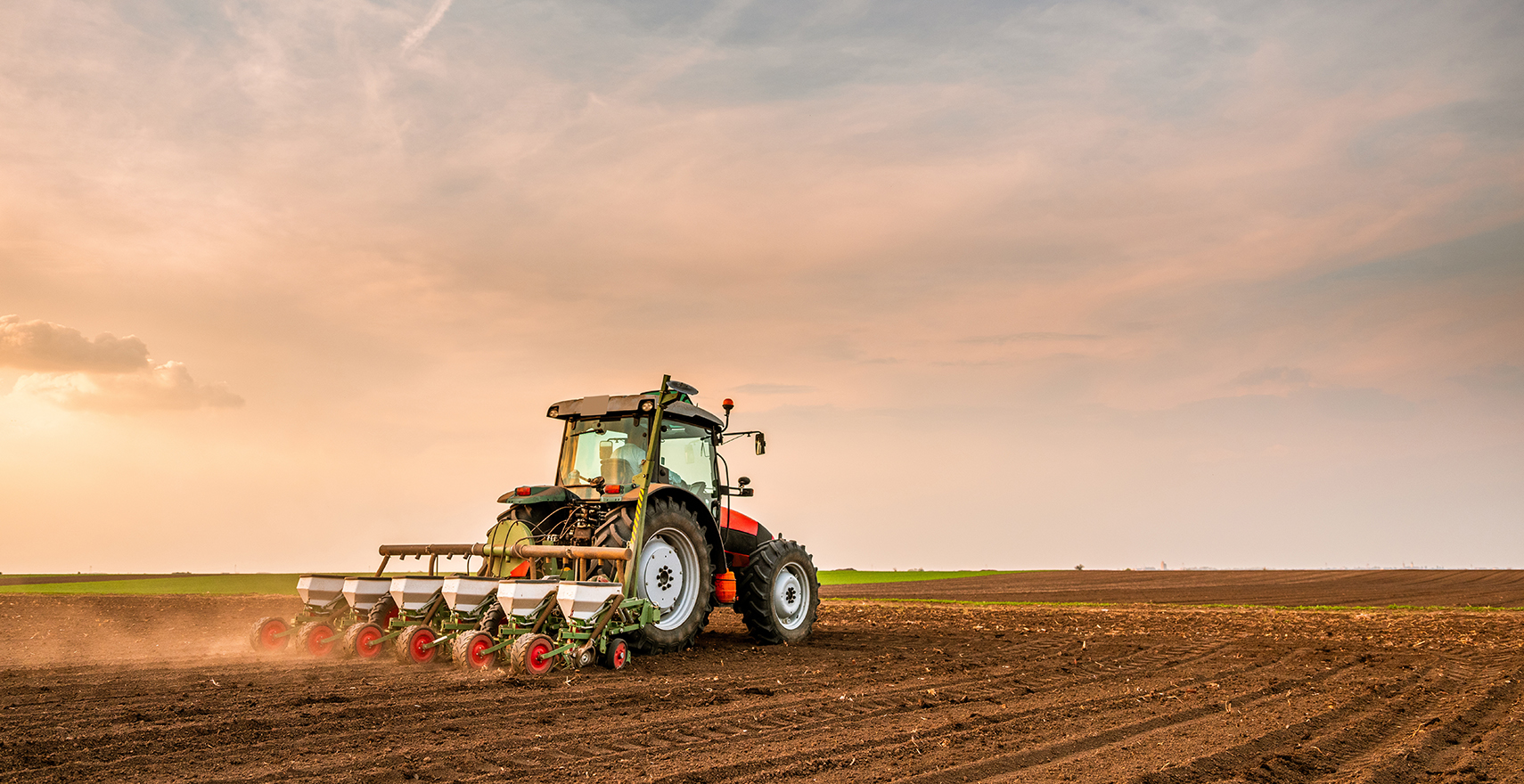 tractor plowing up dirt